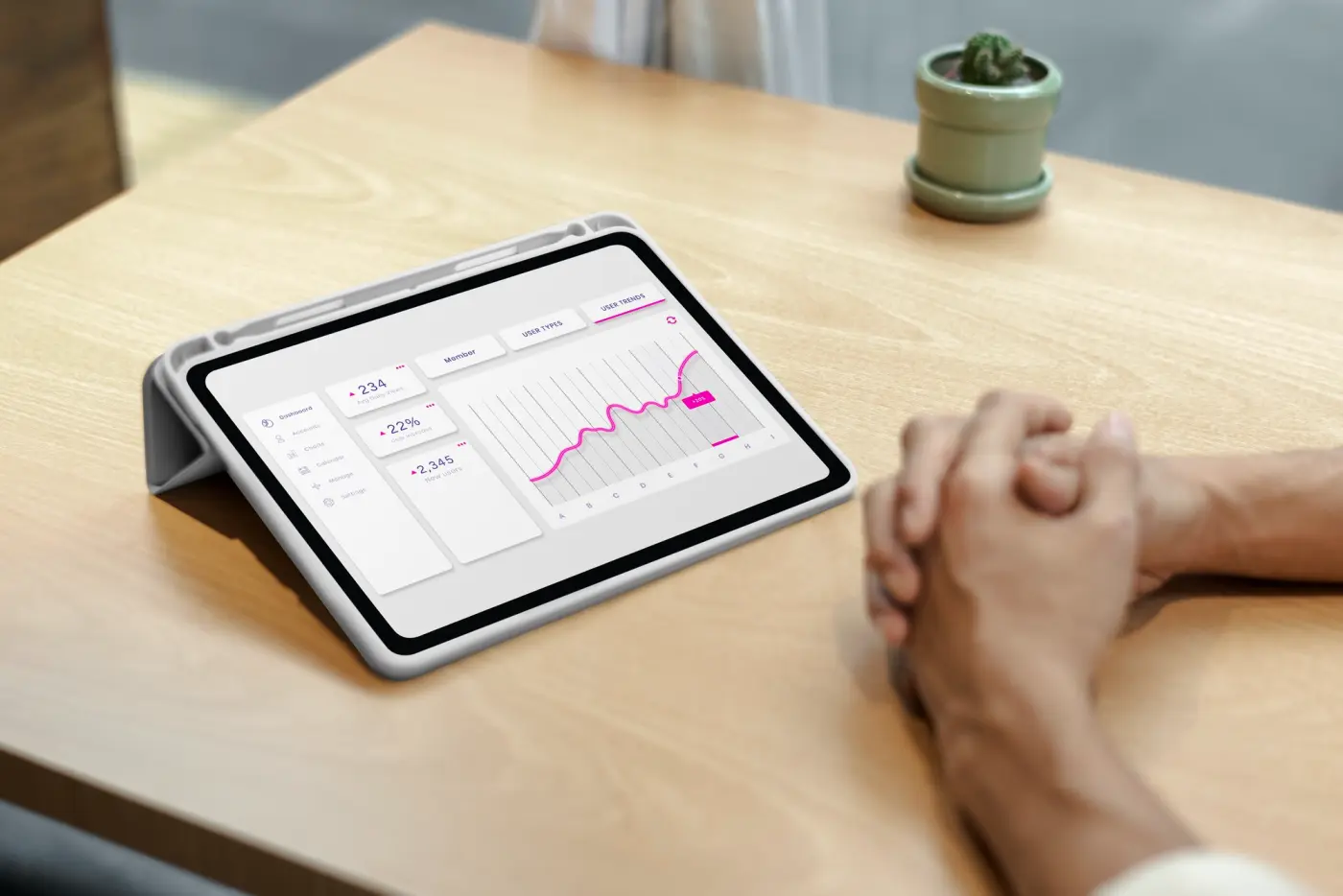 A tablet on a desk showing a dashboard with a line chart